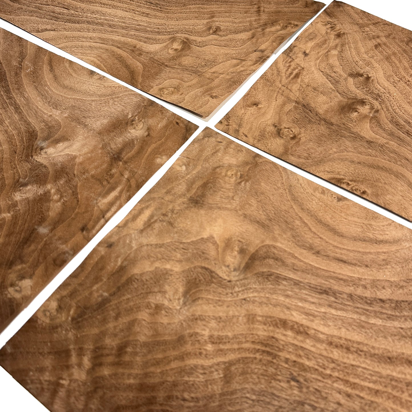 Wooden surface with a swirling pattern, divided into four sections.