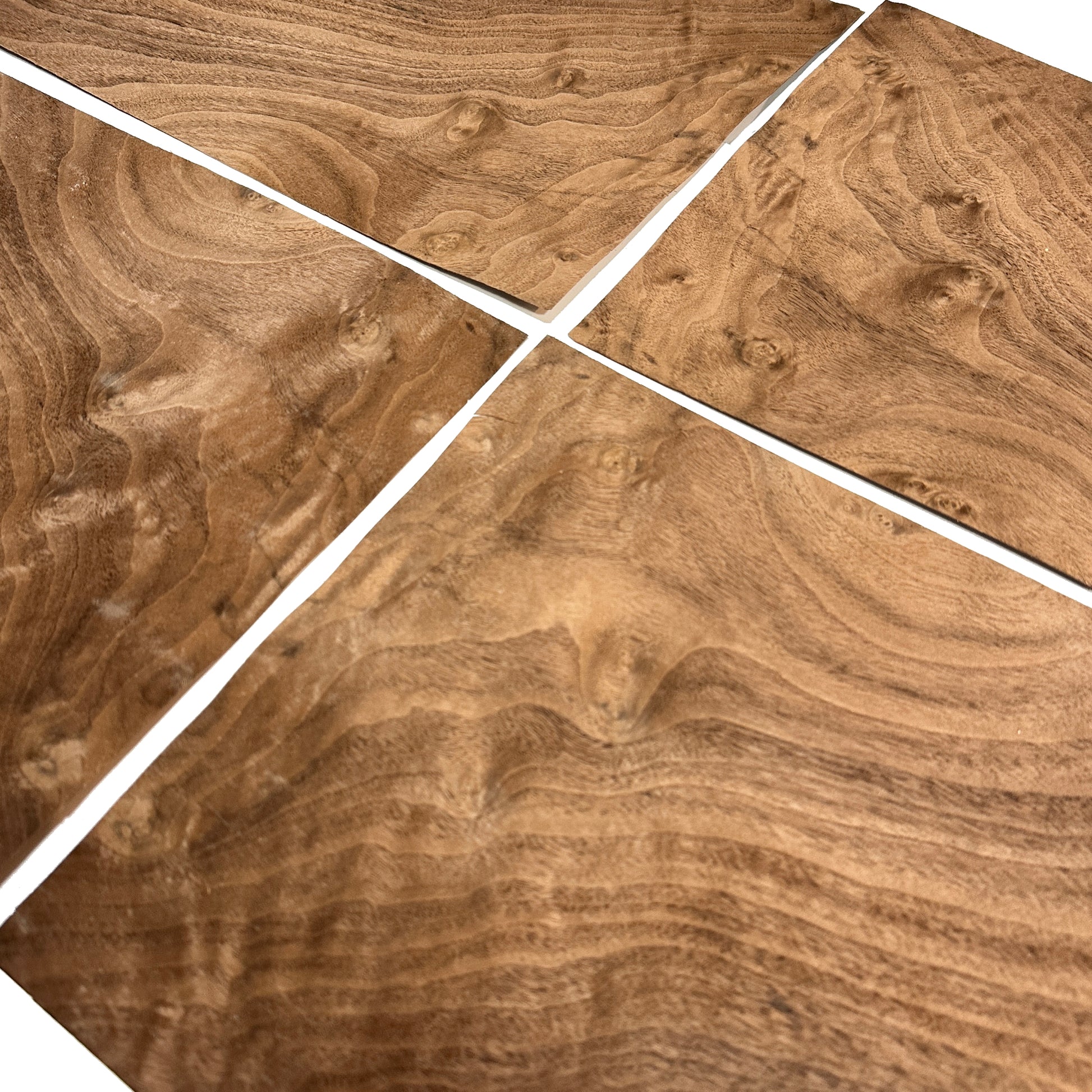 Wooden surface with a swirling pattern, divided into four sections.